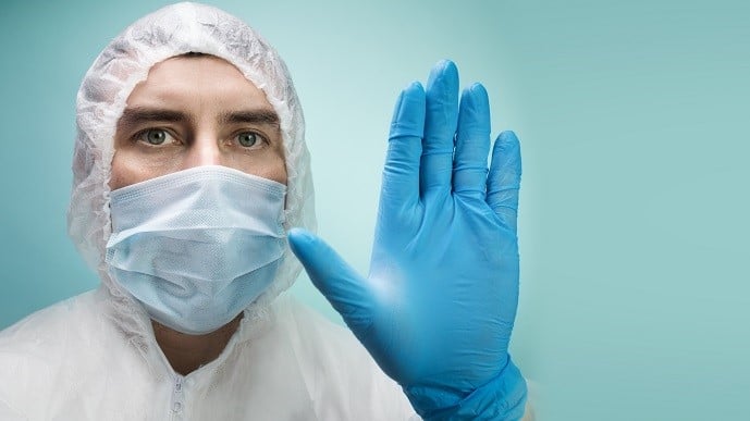 A Cleanroom Operator makes stop gesture with hand